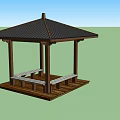 Outdoor Wooden Pavilion With Black Roof Benches And Table In Green Landscape Under Blue Sky