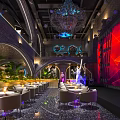 Modern Bar Interior Featuring Chandelier Arched Structures Large Screens Stage And Plant Decorations