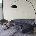 Unique Shaped Gray Sofa In Modern Interior With Round Coffee Table And Floor Lamp