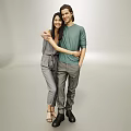 Two Happy People Embracing In Casual Outfits Against Neutral Studio Background