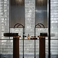 Modern Double Sink Vanity With Glass Brick Wall Black Faucets Wooden Bases And Mirrors