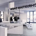 Modern Clothing Store Interior With White Display Platforms Hanging Clothes And Accessories