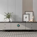 Modern TV Stand With Gray Drawers Black Countertop Circular Decor Green Plant And Decorative Frames