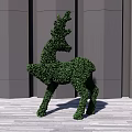 Topiary Bush Shaped as Deer Against Grey Wall and Wooden Floor