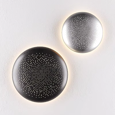 Modern Round Perforated Wall Lamps in Black and Silver with Warm Light Glow on White Wall 3d model