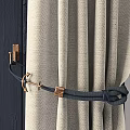Beige Pleated Top Curtains With Tiebacks By Window Featuring Misty Bare Tree View