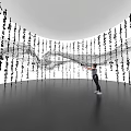 Museum Exhibition Featuring Flowing Art Installation With Hanging Black Characters And White Gray Background