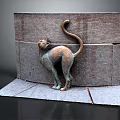 Bronze Cat Sculpture With Curled Tail Standing Against Rustic Stone Wall