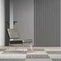 Gray Leather Lounge Chair With Metal Legs Against Vertical Slat Wall And Geometric Rug