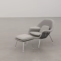 Modern Gray Upholstered Lounge Chair With Matching Ottoman In Minimalist Interior Space