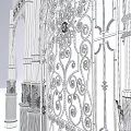 Wrought Iron Arched Gate And Decorative Door With Intricate Patterns And Pillars