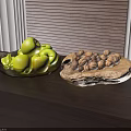 Green Apples In Black Plate And Walnuts In Wooden Tray On Dark Wooden Table