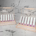 Elegant Decorative Ornament Display Set With White Cylindrical Pieces On Gray Textured Countertop