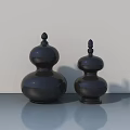 Two Black Gourd Shaped Decorative Sculptures On Smooth Surface With Light Background 3d model