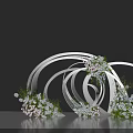 Artistic Floral Installation with Intertwined White Circular Frames White Pink Flowers and Green Foliage