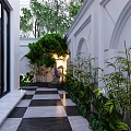 Elegant Garden Landscape With Black Iron Gate White Walls Shaped Tree And Checkered Path