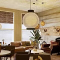 Warm Cozy Café Interior With Hanging Lamps Sofa Seats And Green Plants
