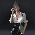 Woman In White Shirt And Black Leather Skirt Holding Green Notebook Against Dark Background