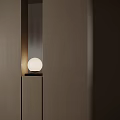 Modern Minimalist Table Lamp With White Globe Shade And Black Base On Wooden Surface