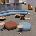 Modern Public Office Space With Multiple Seating Areas Sofa Tables Partitions And Green Plants