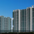 Modern High Rise Residential Building Against Blue Sky With Green Plants And Water Reflection