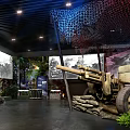 Historical Military Exhibition Hall Interior With Vintage Cannon Sandbags Murals Green Plants And Benches