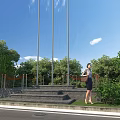 Rural Landscape With Green Trees Lush Grass Blue Sky And Flagpoles Near Steps
