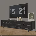 Modern Black TV Stand with Circular Pattern and Decorative Items Under Wall Mounted TV
