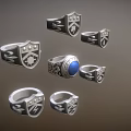 Stylish Emblem Design Rings With Central Blue Gemstone And Silver Settings