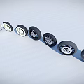 Car Tires With Various Stylish Designs Arranged On White Ground Under Cloudy Blue Sky