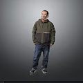Man Standing Against Gray Background Wearing Green And Dark Green Jacket Blue Jeans And Sneakers