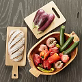Fresh Eggplants Zucchinis Bell Peppers Tomatoes and Bread on Wooden Cutting Boards and Tray