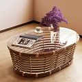 Oval Rattan Coffee Table With Magazine Small Cup And Purple Flowers In Living Room