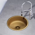 Round Golden Kitchen Sink with Silver Faucet on Gray Countertop