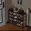 Multi Tiered Shoe Rack With Various Shoes Vase Radio And Handbag In Entryway