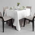 Dining Table Set With White Tablecloth Four Chairs Light Seats Black Legs Tableware Vase Flowers