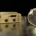 Vintage Electronic Device With Control Knobs And Metallic Reflective Disc