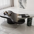 Modern Coffee Table with Irregular Black Tabletop and Marble Base Adorned with Golden Decorative Objects