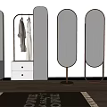 Stylish Gold Frame Mirrors with Clothes Rack White Cabinet and Plant on Wooden Floor