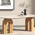 Oval Dining Table with Light Marble Top Arched Wooden Legs Black Vase and Green Plant