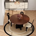 Round Wooden Table And Two Black Chairs with White Cushions and Flower Vase by Window