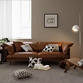 Modern Brown Leather Two Seater Sofa With Black White Throw Pillows Floor Lamp And Potted Plant