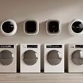 Four White Front Loading Washing Machines With Wall Mounted Dryers In Laundry Room