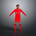 Liverpool Football Player Wearing Red Jersey With Team Logo And Shorts