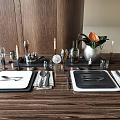 Elegant Tableware Set with Plates Cutlery Wine Glasses and Candle Holders on Wooden Dining Table