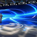 Modern Stage With Large Blue Illuminated Screen Circular Light Lines Podium White Seats And Audience
