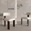 Poliform Dining Chairs With White Seat And Dark Legs By White Wall And Green Plant