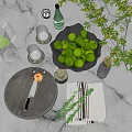 Ceramic Bowl Filled With Fresh Limes On Kitchen Counter With Glasses Coasters And Green Plant
