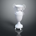 White Decorative Vase With Ornate Handles And Carved Floral Details On Pedestal Base