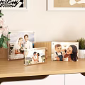 Decorative Photo Frame Set with Wedding Family Photos on Wooden Shelf Green Plant White Flowers